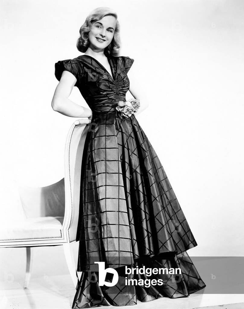 THE BRIDE CAME C.O.D., Lucile Fairbanks, modeling a silk taffeta gown in bright blue with lime checks, 1941