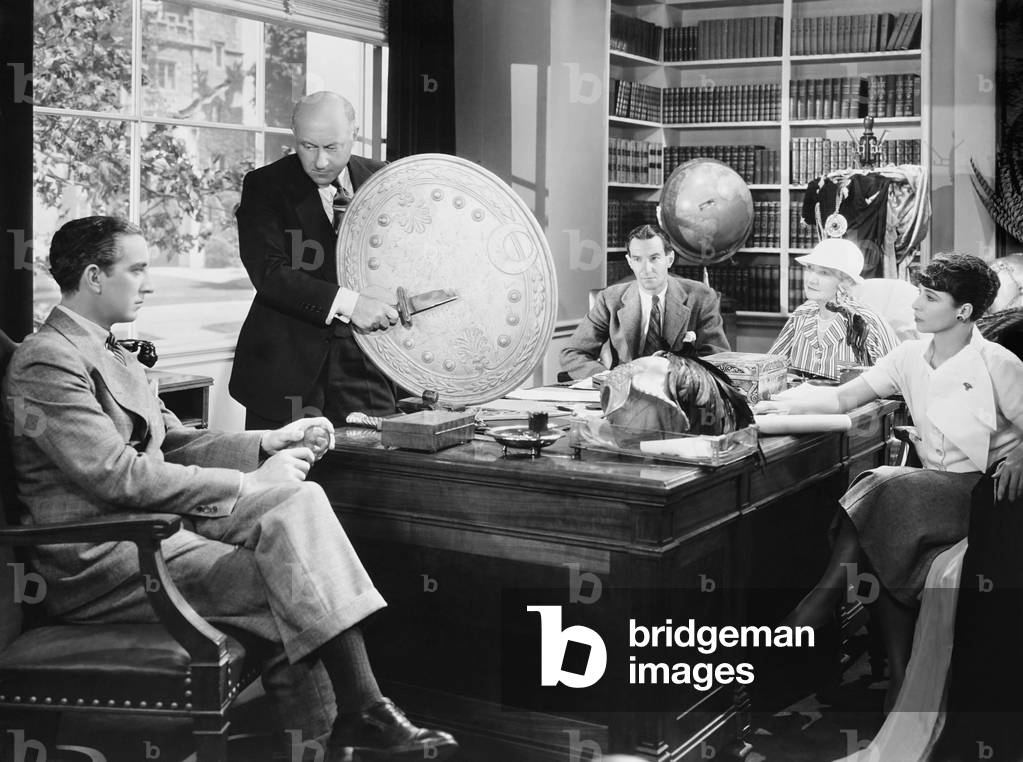THE CRUSADES, director Cecil B. DeMille (standing) meeting in his office with from left: art director Ralph Jester, assistant director David MacDonald, editor Anne Bauchens, script girl Emily Barrye, 1935