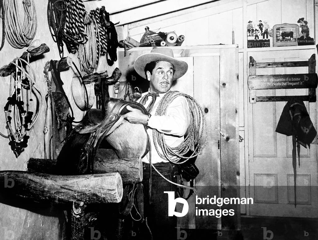 MEN OF TEXAS, Leo Carrill, on location at his own San Diego ranch with one of his horses, 1942