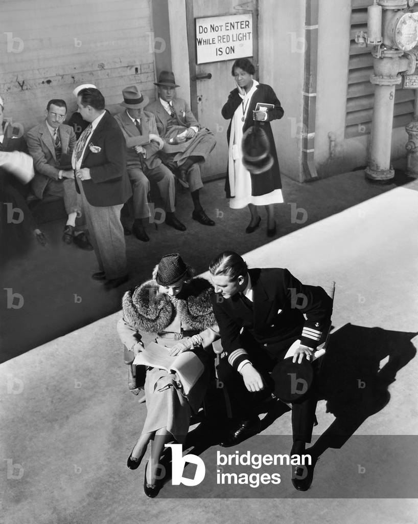EIGHT BELLS, front from left: Ann Sothern, John Buckler study the script outside the sound stage, 1935