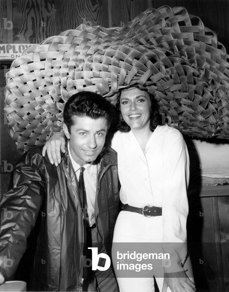 DIAMOND HEAD, from left, George Chakiris, Elizabeth Allen, taking shelter under Allen's enorous hat while filming in Kauai, March 1962