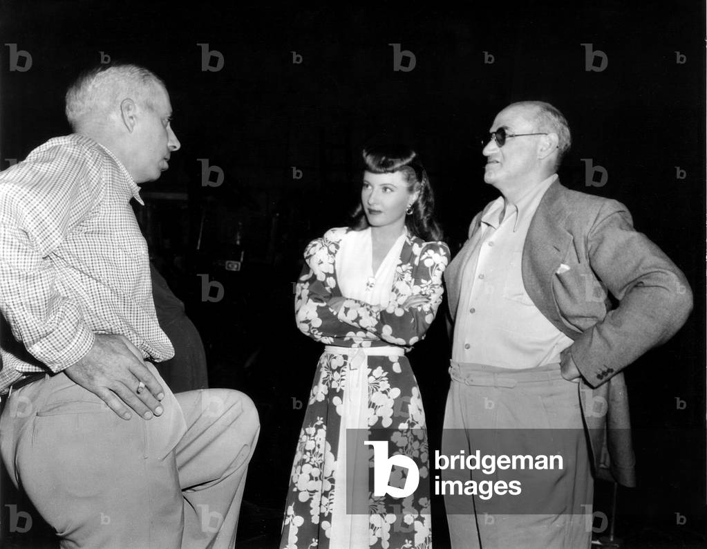 BALL OF FIRE, from left, director Howard Hawks, Barbara Stanwyck, producer Samuel Goldwyn, on-set, 1941