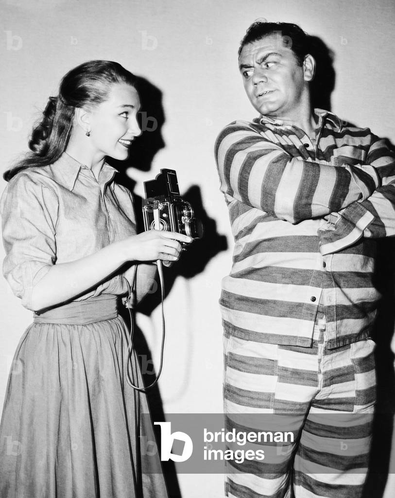 THE BADLANDERS, from left: Tania Elg visiting Ernest Borgnine on set, 1958
