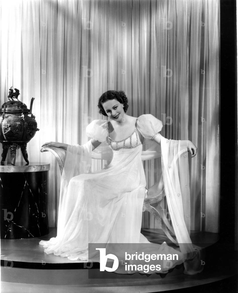 ANTHONY ADVERSE, Olivia de Havailland, in a white satin, rhinestone-trimmed gown by Milo Anderson, 1936