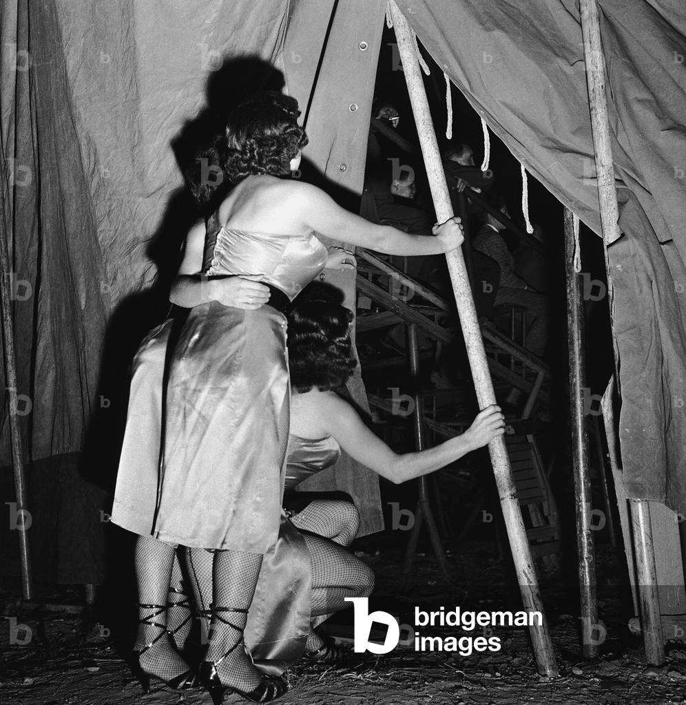 Two women of the Palmeri circus while watching a circus number, Italy (gelatin silver print)