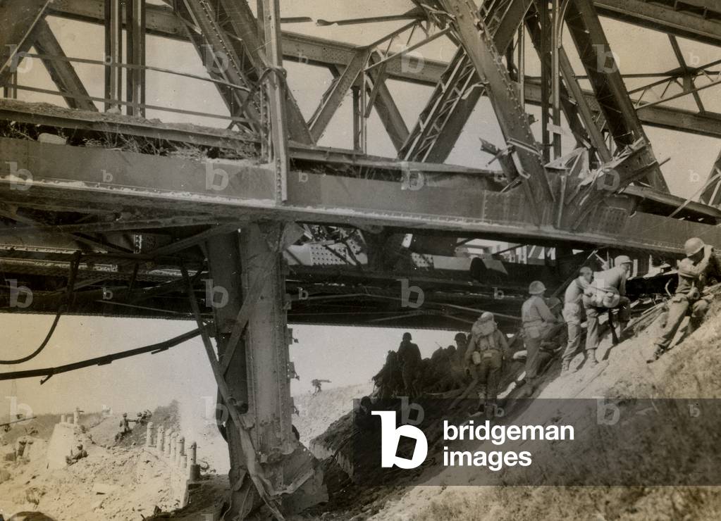 American cross the Po: American group wait under a bomb battered bridge (b/w photo)