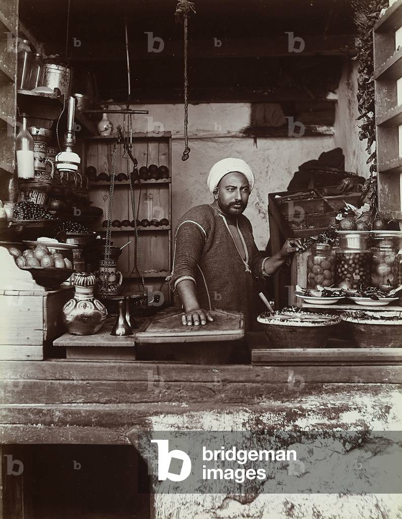 A Turkish food vendor, photographed behind the counter of his shop, 1890 (print on double-weight paper)
