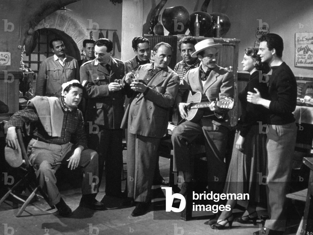 Mario Riva, Fiorenzo Fiorentini, Helene Remy and Franco Interlenghi interpreting a scene in a tavern on the set of Giorgio Pastina's film 'Giovinezza'
