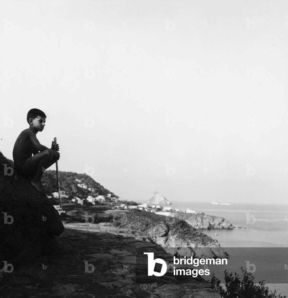 Child looking out to sea from the island of Panarea (b/w photo)