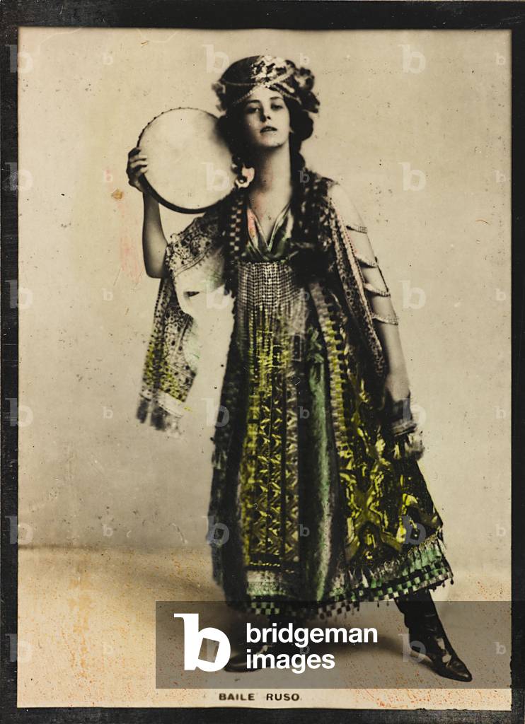 A young woman in traditional costumes dancing a folk Russian dance