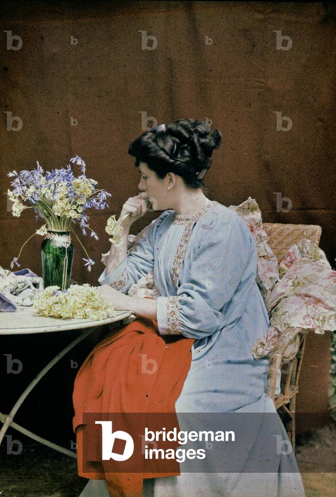 Seated woman with a vase of flowers, France