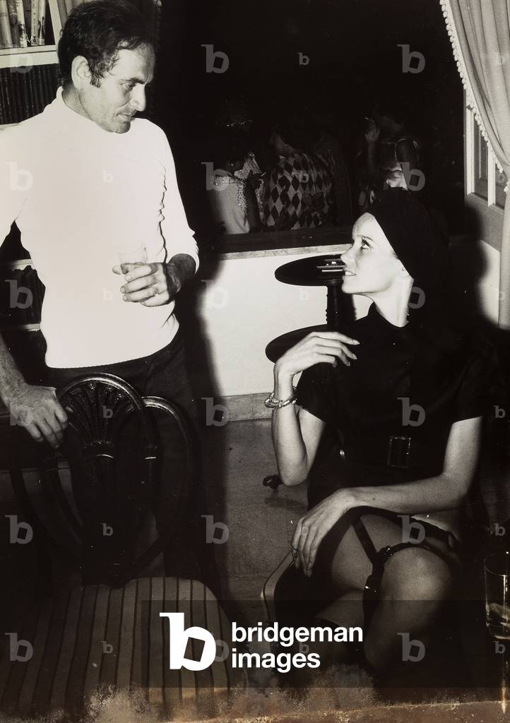 The model Veruschka and the stylist Pierre Cardin at a reception.