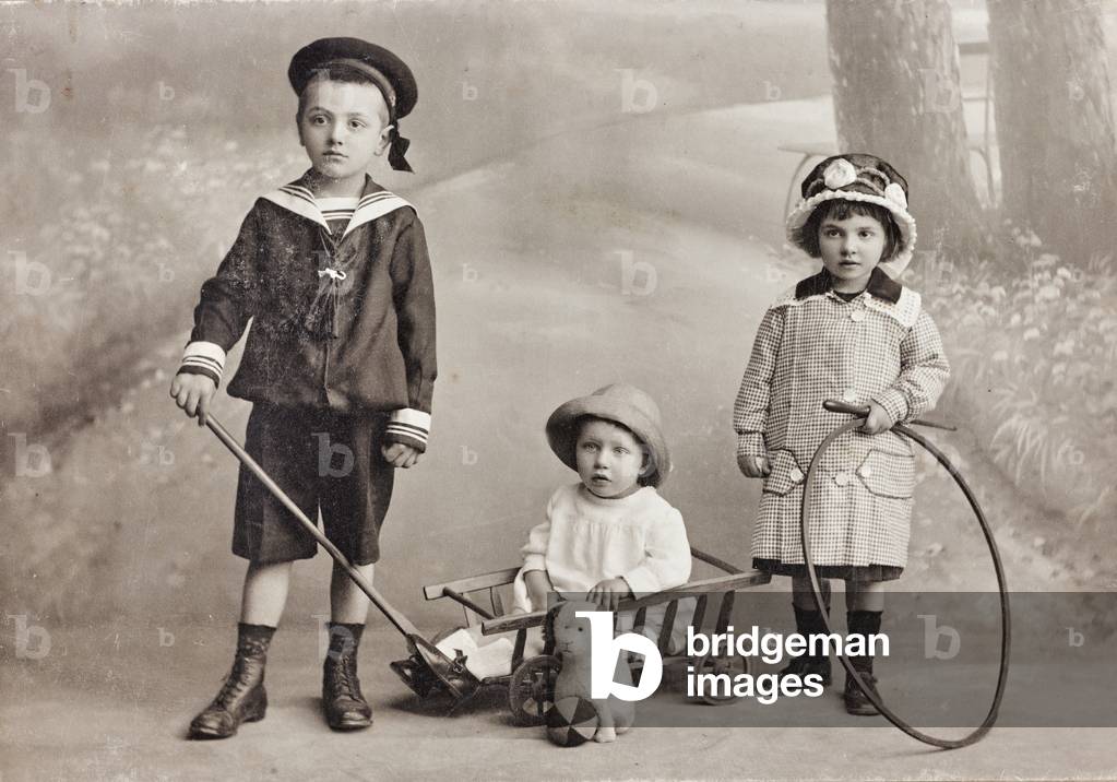A child dressed like sailor and his sisters