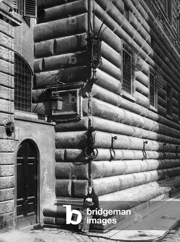Newspaper seller seated at one of the corners of the Palazzo Strozzi, Florence