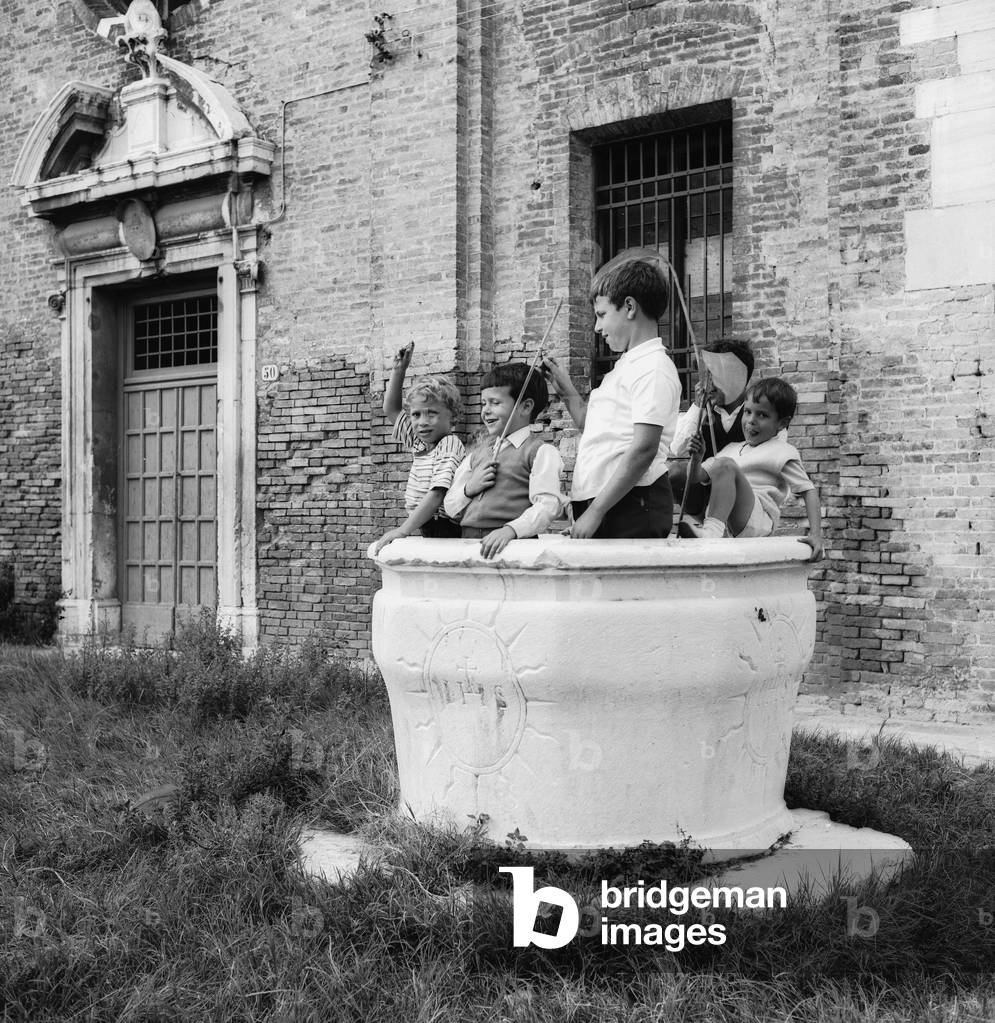 Children playing outdoors (b/w photo)