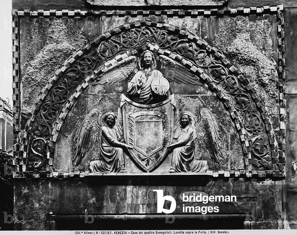 Lunette decorated with a 14th century bas-relief, on the door of the Casa dei Quattro Evangelisti in Venice