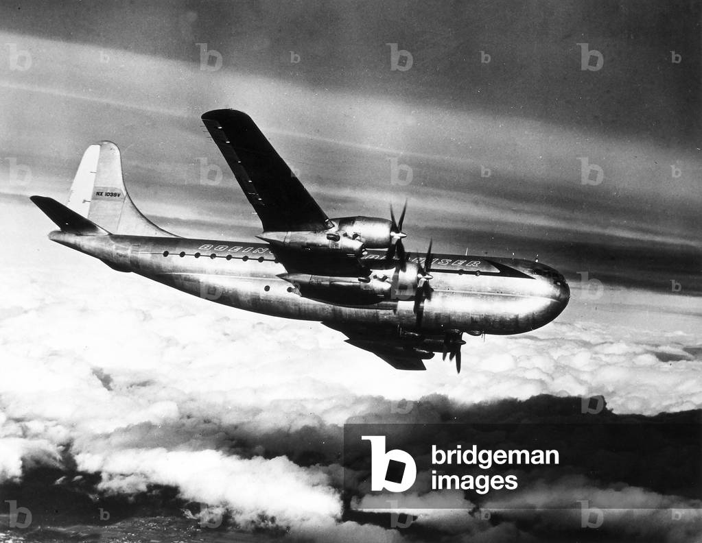 A Boeing B-377 Stratocruiser airplane with four commercial engines with a pressurized cabin, photographed in flight.