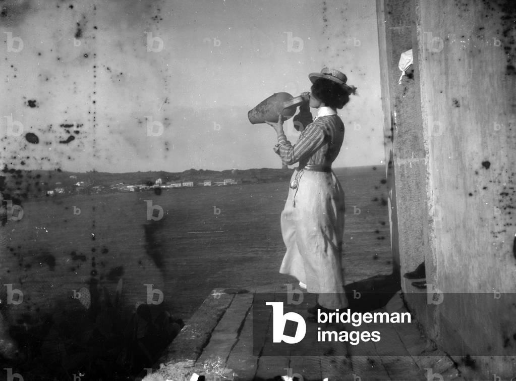 Portrait of woman photographed while drinking from a jar