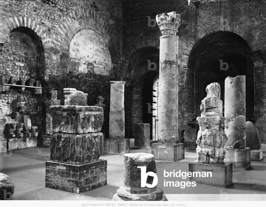 A room in the Musée National du Moyen Âge where a few architectural structures and several sculptures from the Middle Ages are on display; the Museum is in the Thermes et Hôtel de Cluny in Paris