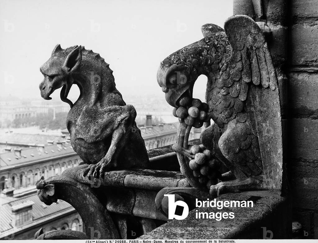 Detail of two monstrous figures located on a terrace in the Cathedral of Notre-Dame, Paris