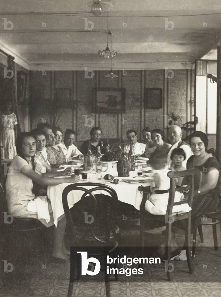 Portrait of a family gathered around a table