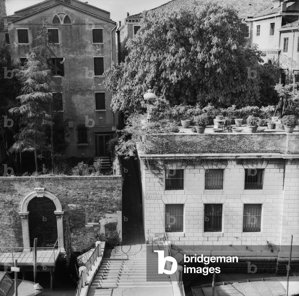 Buildings with terraces on a Venetian canal (b/w photo)