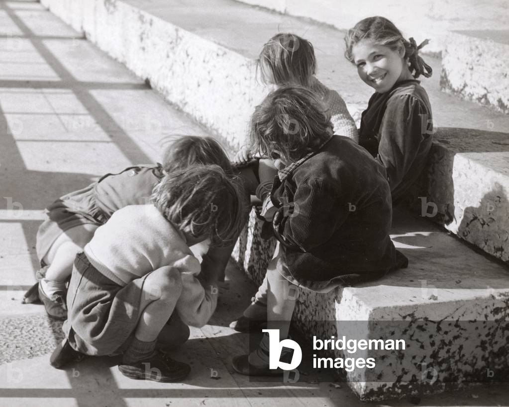 Some little girls playing in the street