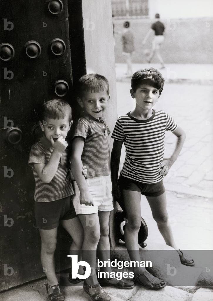 Three children on the doorstep of a house