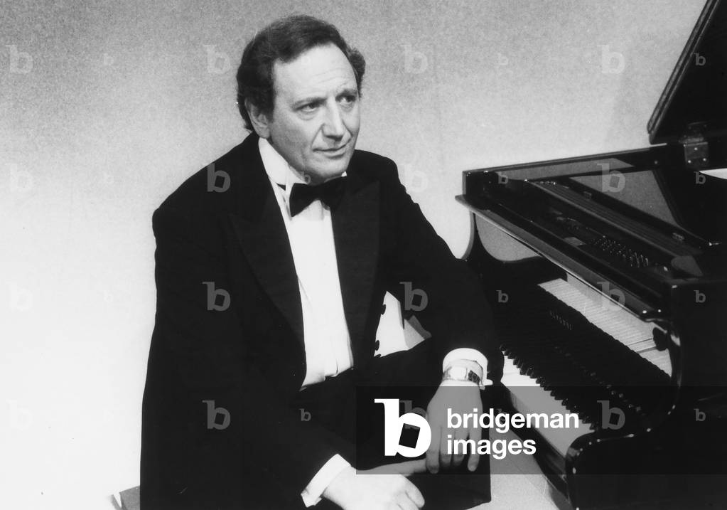 The pianist Dino Siani sitting in front of a piano.