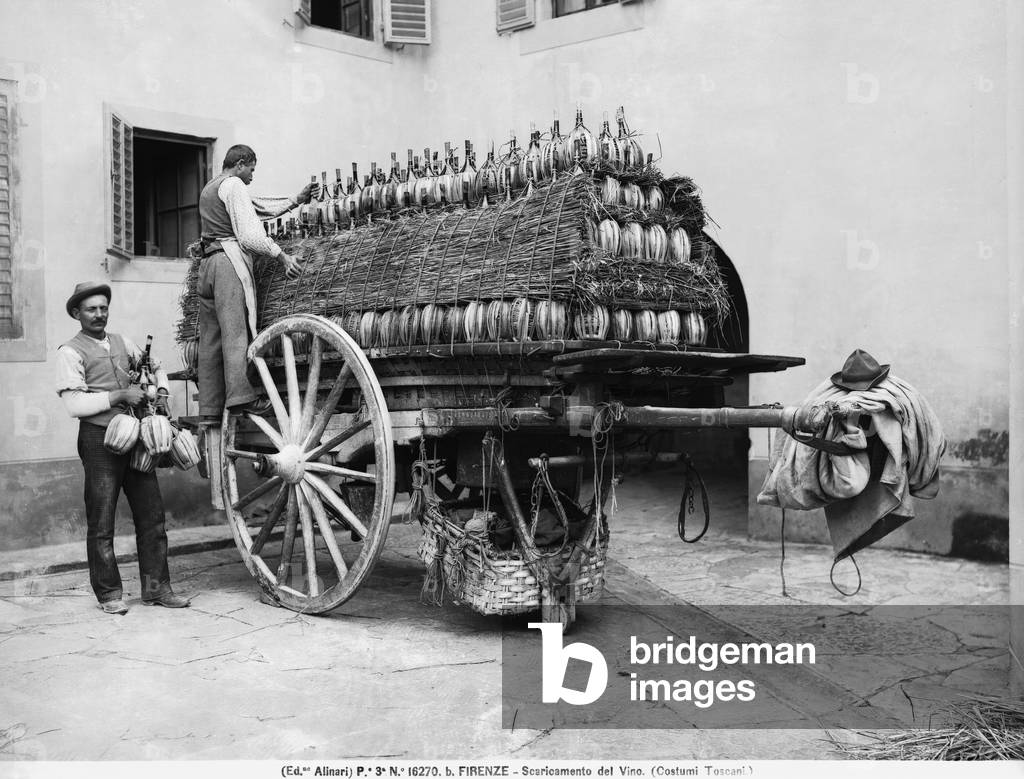 Men unloading flasks of wine from a cart