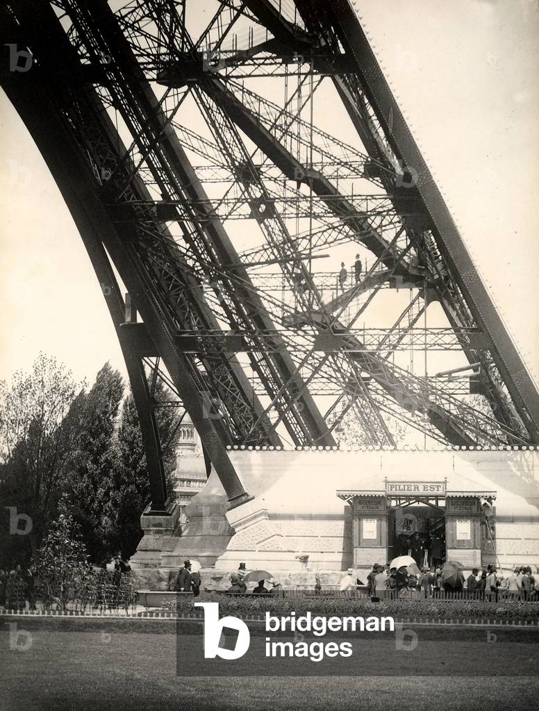 Word's Fair of 1889: Parisians in line for the elevator with oriental pylons at the Eiffel Tower.