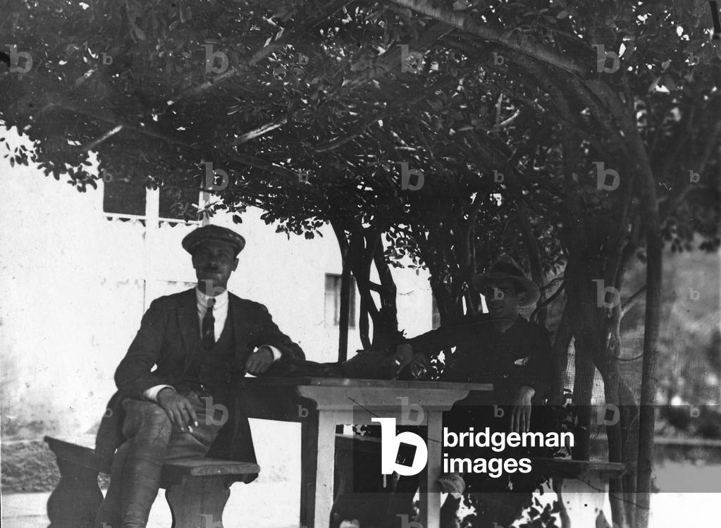 Portrait of two men under a pergola