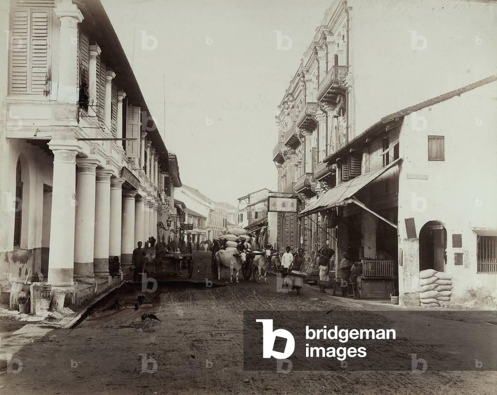 Carts and men transporting merchandise, in the main road of Penang, Malaysia, 1910 (print on double-weight paper)