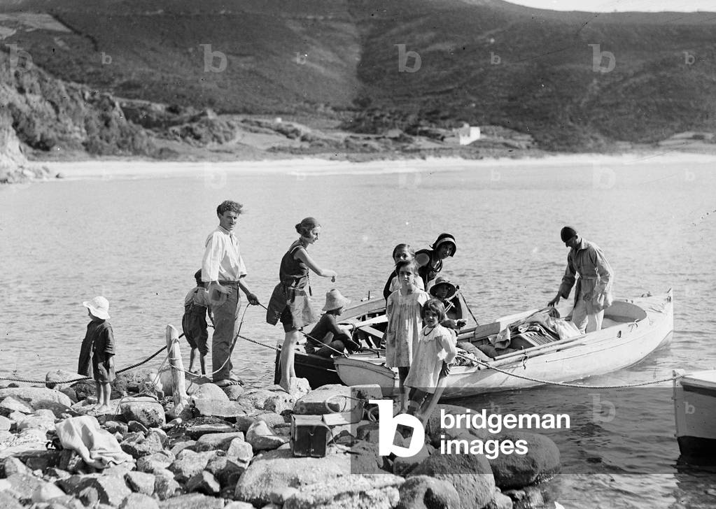 Group of tourists on board a boat on the beach front of the island of Elba Biodola