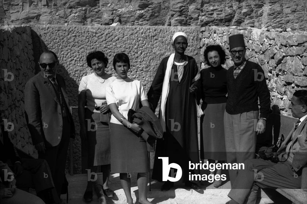 Group photograph of tourists along with a Bedouin, Thebes (ancient Luxor)