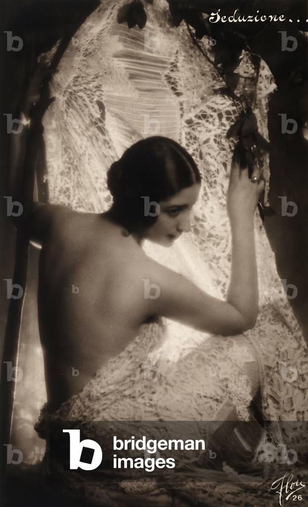Portrait of a young woman shrouded in a white lace cloth