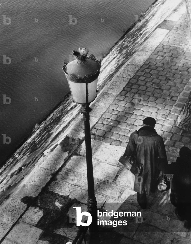 Two elderly people on the river bank