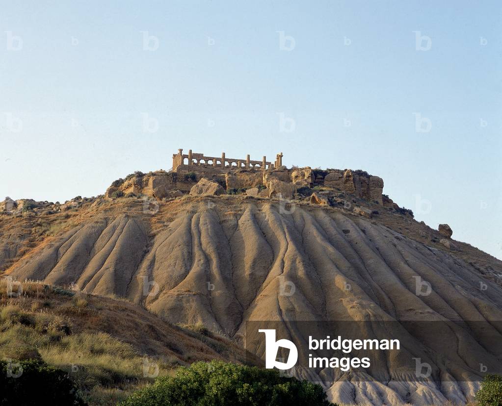 View of the Temple of Juno Lacinia in the Valley of the Temples in Agrigento, misnamed due to some confusion with the Temple of Hera on the Lacinio cliff in Crotone. The Temple is situated on a hilltop of sandstone which has been shaped by the elements.