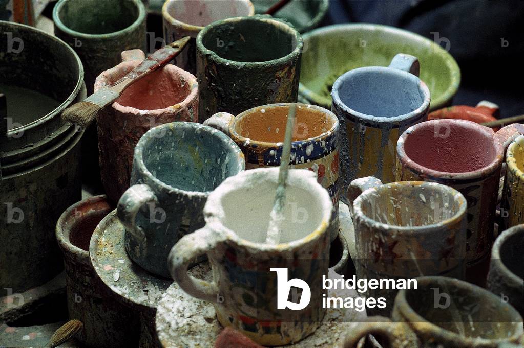 Mugs with paint-covered brushes used for decorating ceramics, Montelupo Fiorentino, Italy (photo)