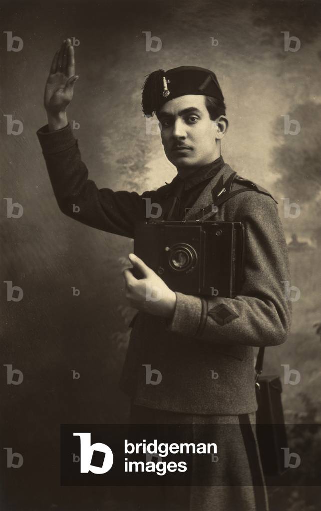Antonio Trombetta jr. uniformed military fascist with camera in hand while making the fascist salute