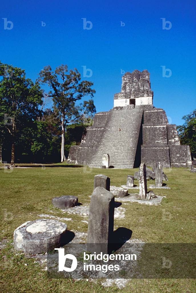 Temple II of the Masks in Plaza Major, with steles and altars along a grassy area, archeological site of Tikal, Guatemala (photo)