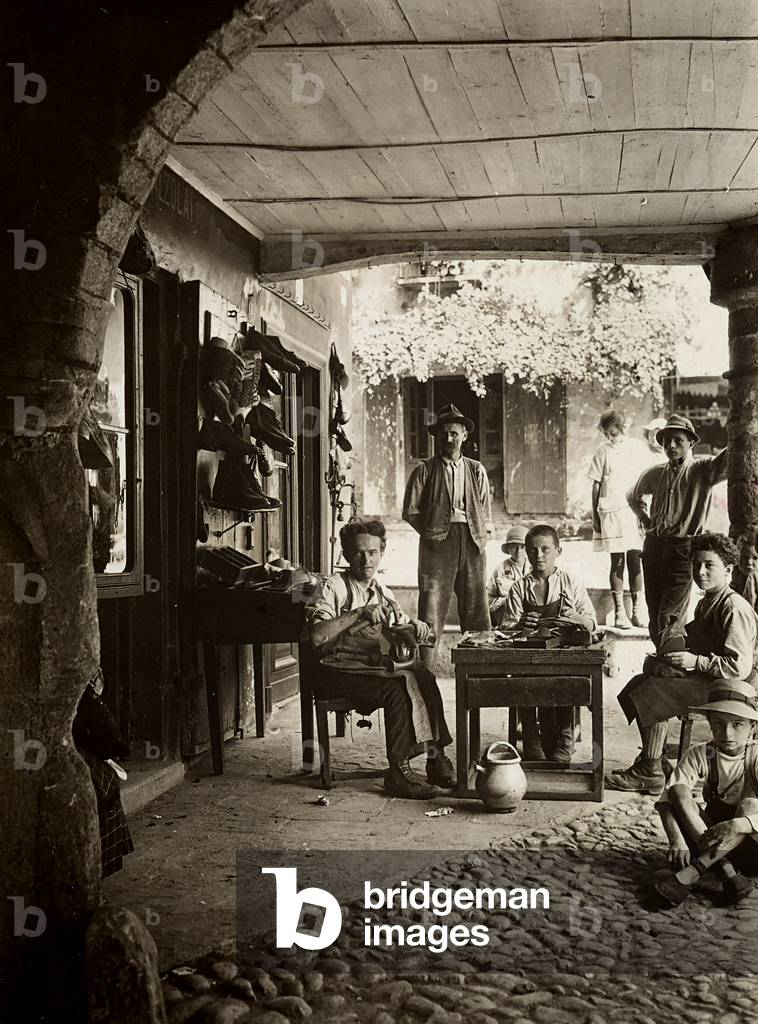 Shoemaker's workshop with a man and two children at work
