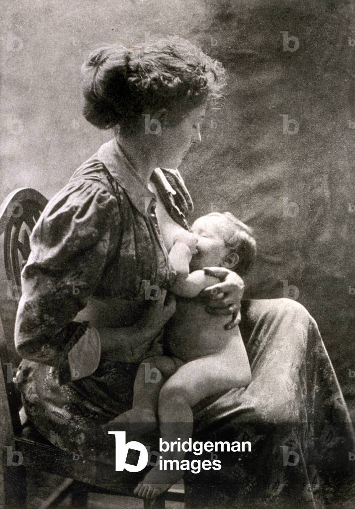 A young mother nursing her infant