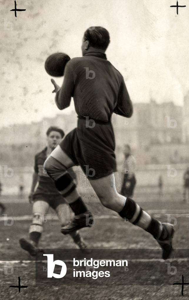 The French soccer player Dessertot seen in action, from the rear, during a game.