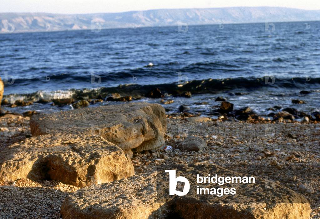 View of the site where Christ multiplied the bread and the fishes, near Tabgha, on Lake Tiberias, in Israel. The worn down stones used to tie up fishing boats can be seen in the foreground