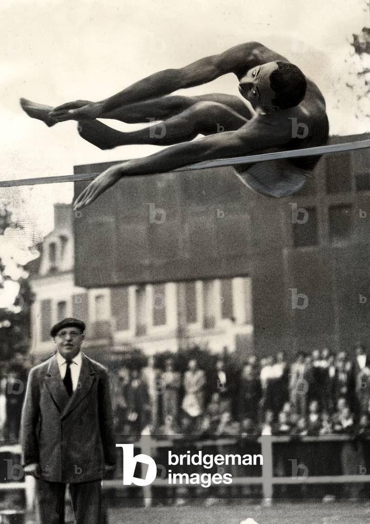 The U.S. athlete Battiste takes a leap in the high jump.