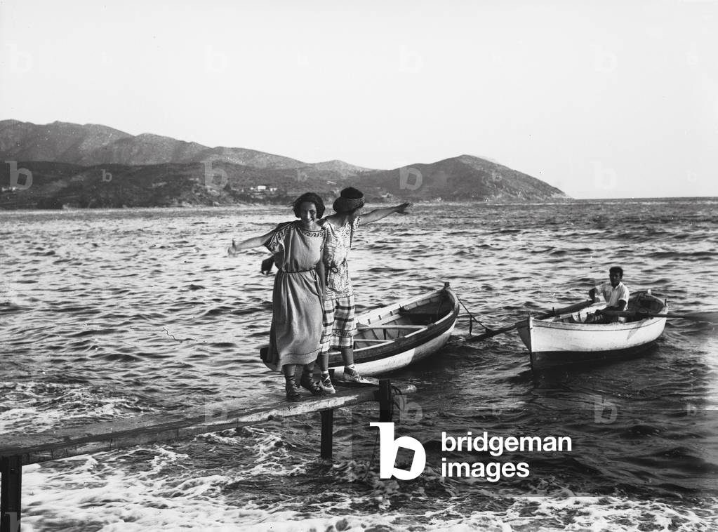 Girls poised on a platform of docking, Portoferraio, Elba Island
