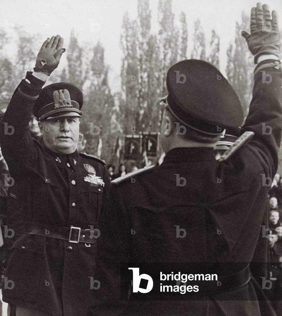 Benito Mussolini honors a fascist official with a salute (b/w photo)