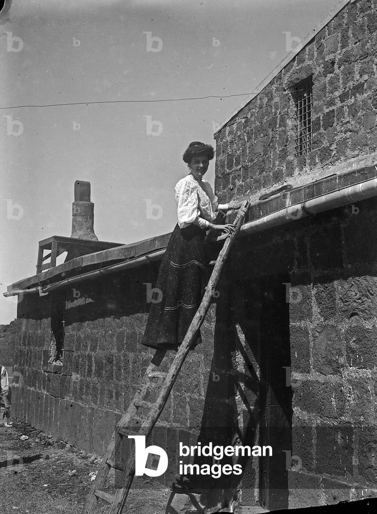 Portrait of a woman on a ladder during an excursion to Mount Etna
