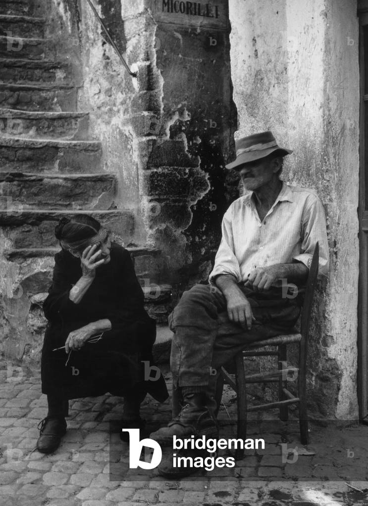Man and woman in front of their house